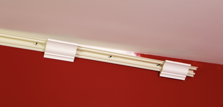 A red wall with white trim and a ceiling.