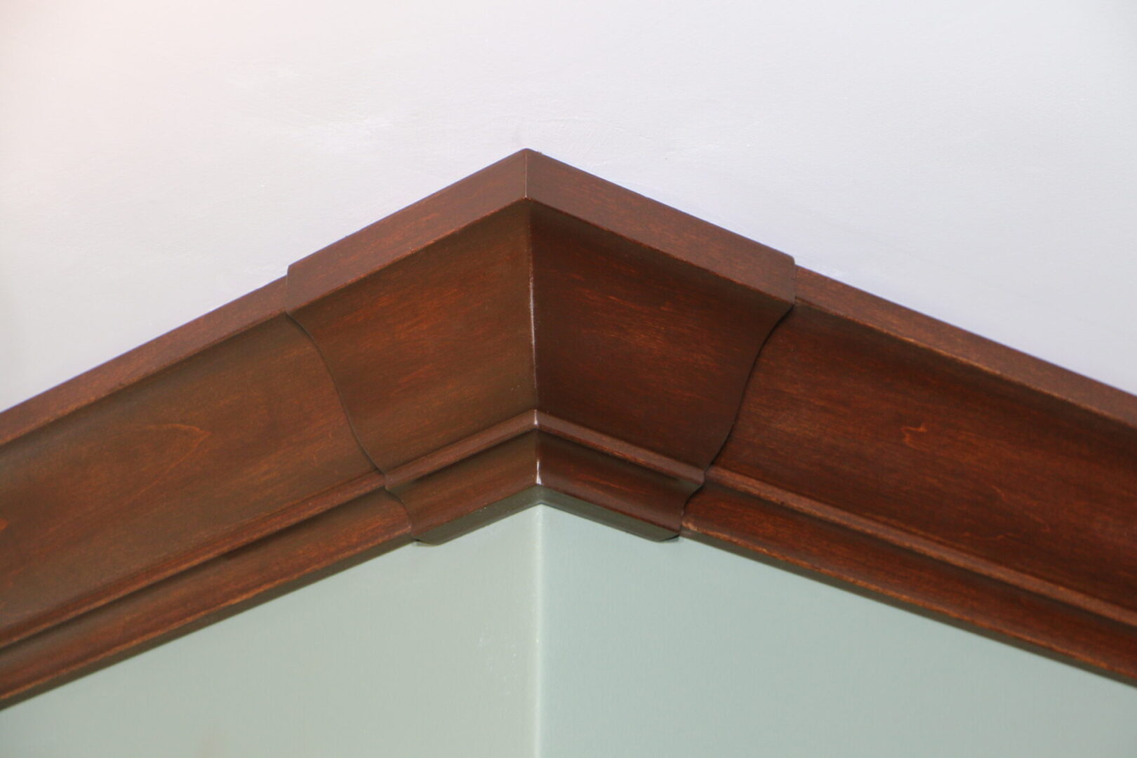 A corner of a room with some wood trim.